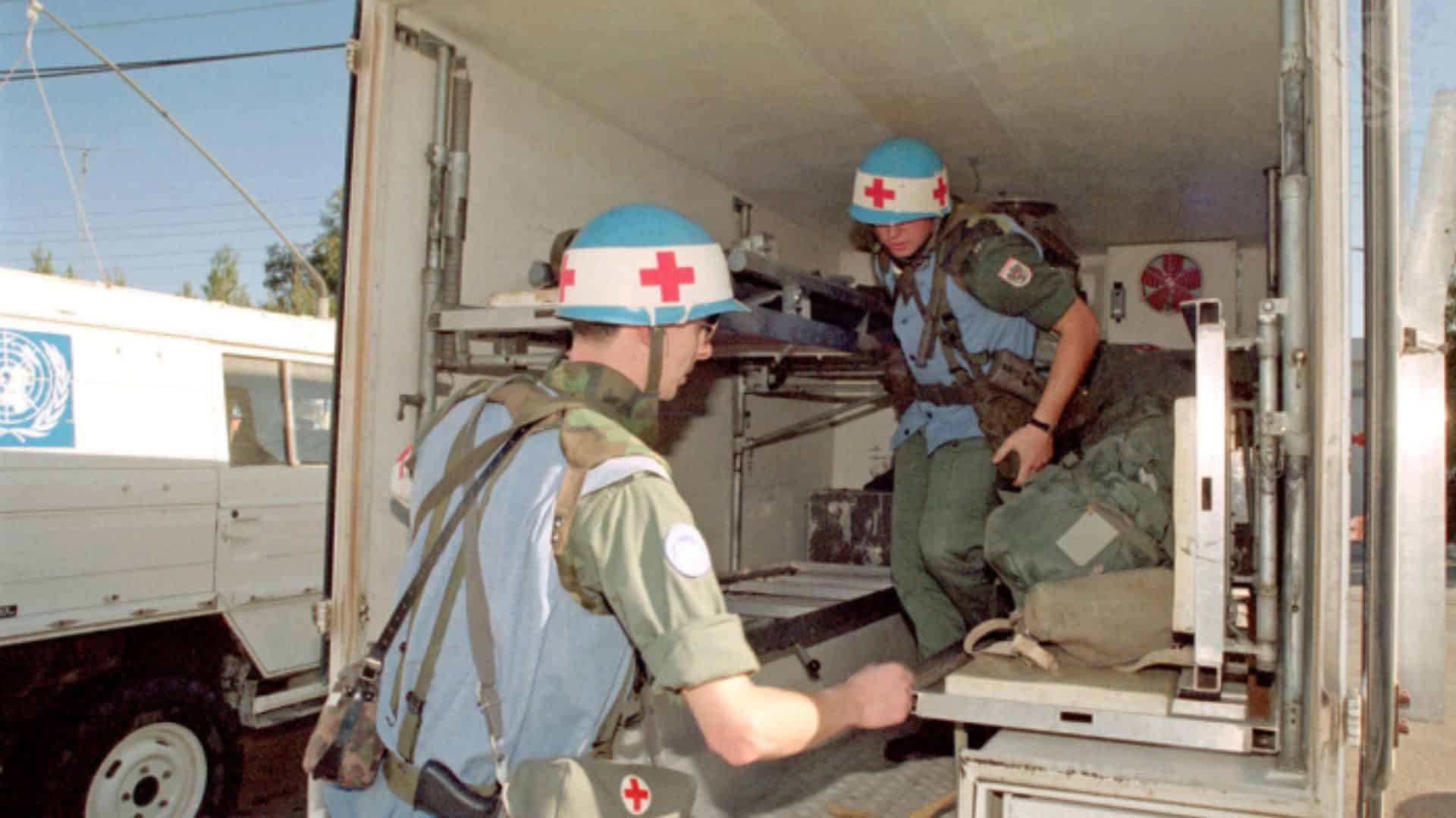 United Nations humanitarian aid workers unload supplies from their vehicle
